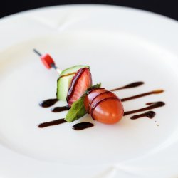 Skewers of cherry tomatoes, cucumbers, strawberries and basil with balsamic vinegar reduction - Cold bites